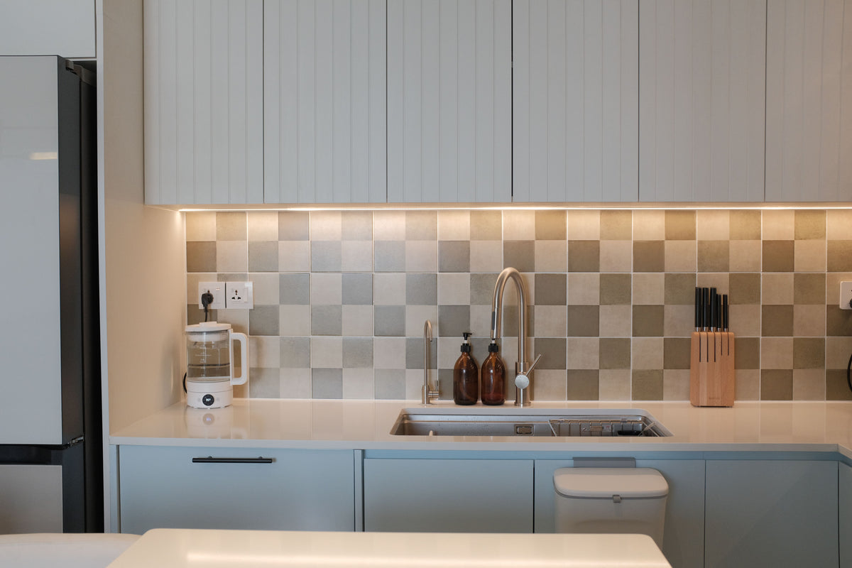 Sleek modern kitchen with chic cabinetry and elegant tile backsplash.